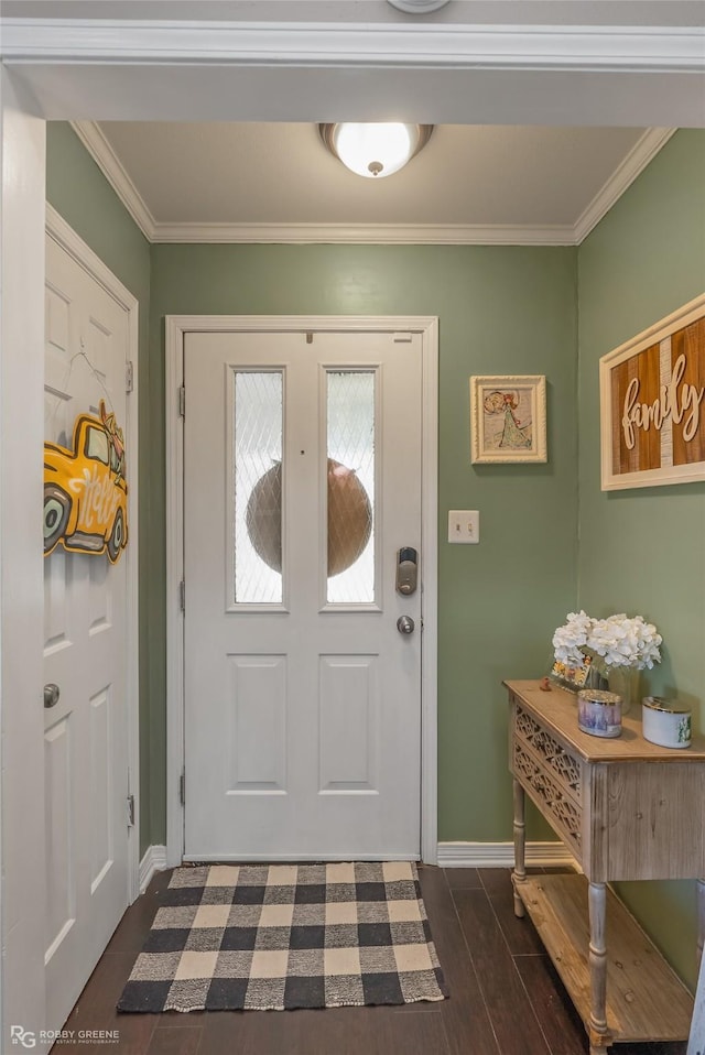 entrance foyer with ornamental molding, dark wood finished floors, and baseboards