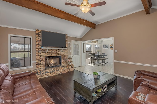 living area featuring vaulted ceiling with beams, plenty of natural light, a fireplace, and wood finished floors