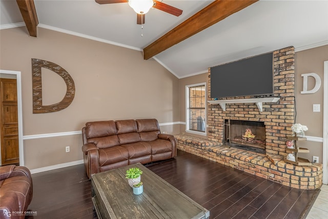 living room featuring baseboards, wood finished floors, vaulted ceiling with beams, crown molding, and a fireplace