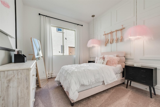 bedroom with light colored carpet and baseboards