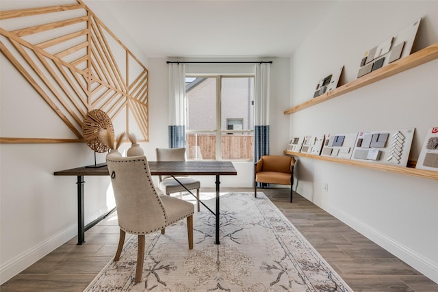 office space with baseboards and wood finished floors