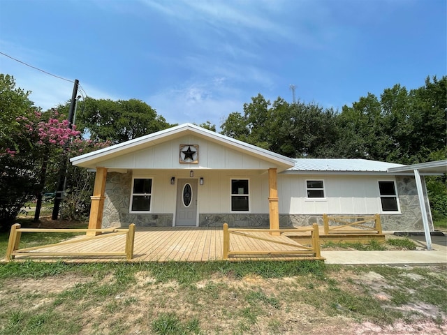 view of front of home with metal roof and stone siding