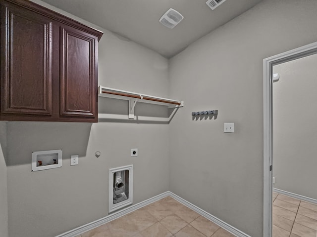 laundry room with cabinet space, baseboards, hookup for a gas dryer, hookup for an electric dryer, and washer hookup