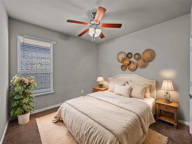 carpeted bedroom with ceiling fan and baseboards