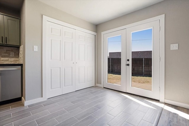 entryway featuring wood finish floors, french doors, and baseboards