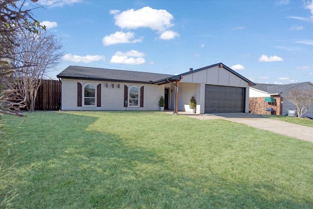 view of front of home with brick siding, fence, a garage, driveway, and a front lawn