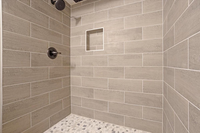 full bathroom featuring tiled shower