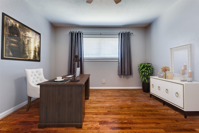 office featuring a ceiling fan, baseboards, and wood finished floors