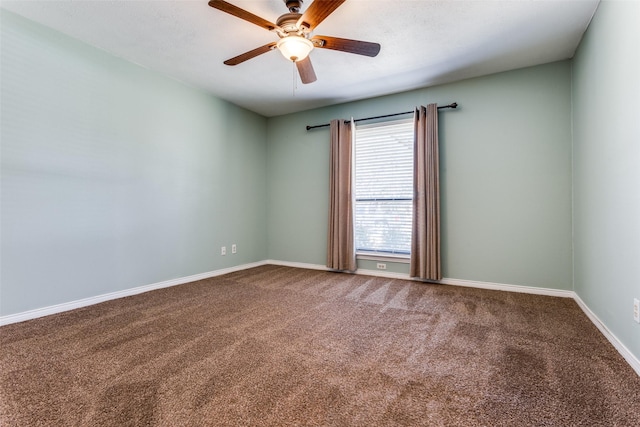 empty room with carpet, ceiling fan, and baseboards