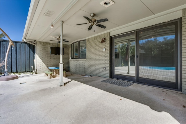 view of patio with ceiling fan and fence