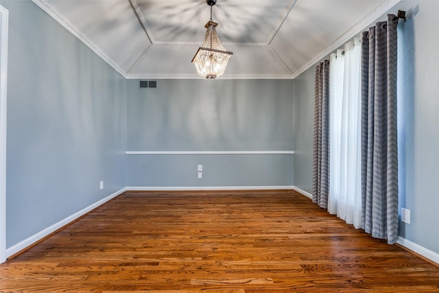 unfurnished room with lofted ceiling, wood finished floors, visible vents, and a notable chandelier