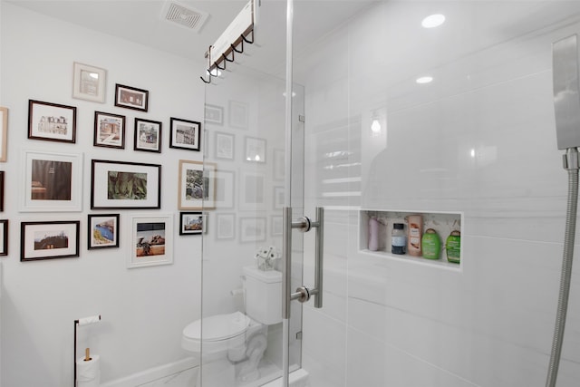 bathroom featuring visible vents, a shower stall, and toilet