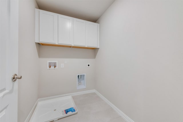 clothes washing area featuring gas dryer hookup, hookup for a washing machine, hookup for an electric dryer, baseboards, and cabinet space