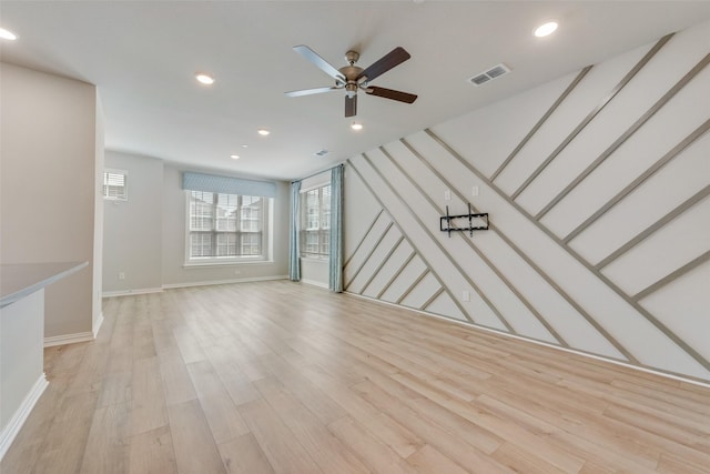 unfurnished living room with recessed lighting, visible vents, a ceiling fan, light wood-type flooring, and baseboards