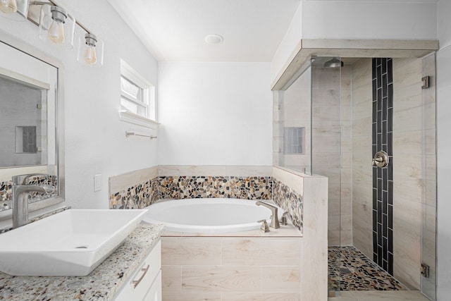 full bath with a stall shower, a garden tub, and vanity