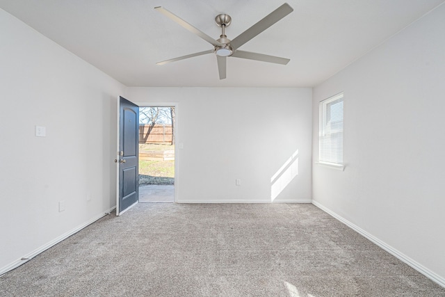 305 W Johnson St, Denison, TX 75020 - carpeted empty room with plenty of natural light, a ceiling fan, and baseboards