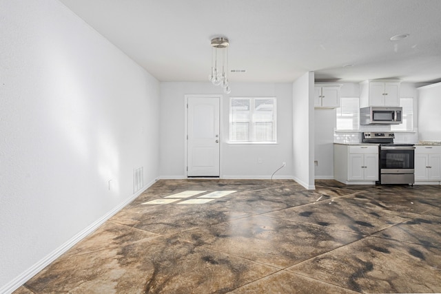 305 W Johnson St, Denison, TX 75020 - kitchen with appliances with stainless steel finishes, baseboards, and white cabinetry