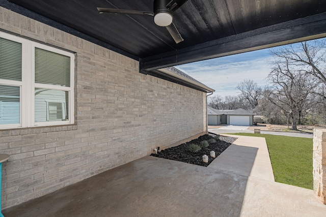 view of patio with a ceiling fan and an outbuilding