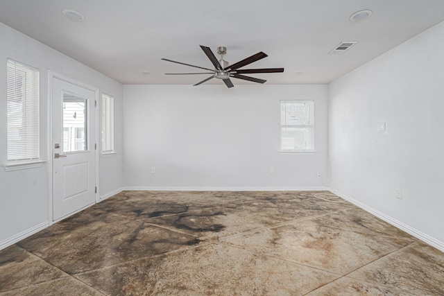 unfurnished room featuring visible vents, plenty of natural light, and baseboards