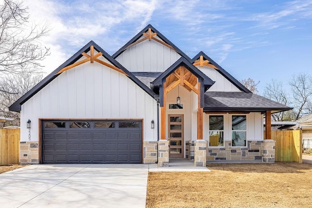 modern inspired farmhouse featuring driveway, a shingled roof, fence, and an attached garage