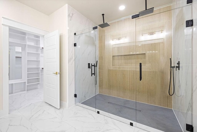 full bath with marble finish floor, a marble finish shower, a walk in closet, and recessed lighting