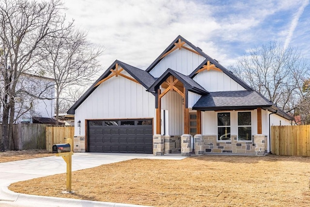 modern inspired farmhouse featuring driveway, a shingled roof, an attached garage, fence, and board and batten siding