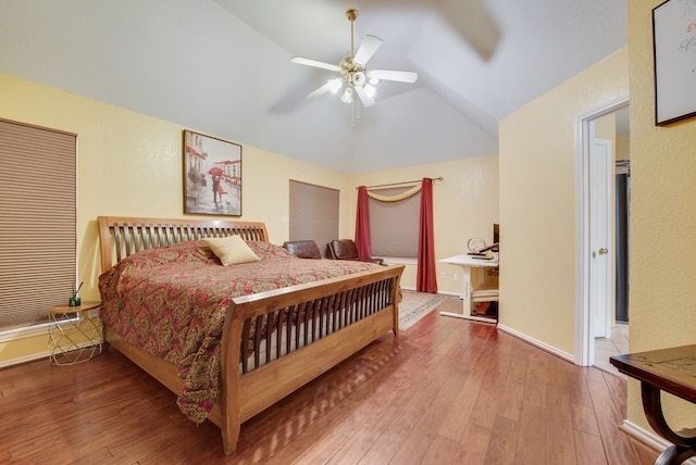 bedroom featuring vaulted ceiling, ceiling fan, hardwood / wood-style floors, and baseboards