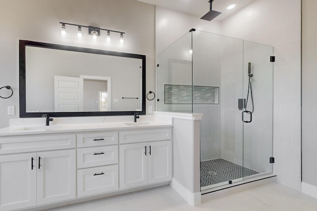 bathroom featuring double vanity, a stall shower, a sink, and visible vents