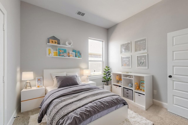 bedroom featuring light carpet, baseboards, and visible vents