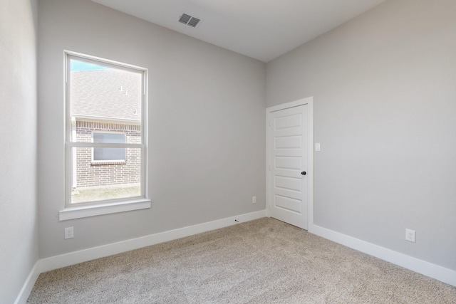 carpeted empty room with visible vents and baseboards