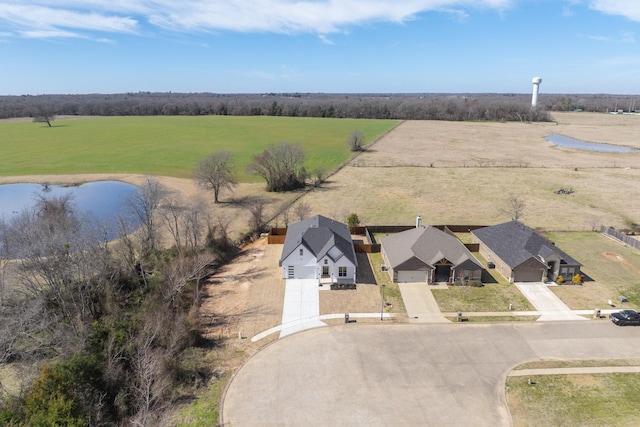 drone / aerial view featuring a rural view and a water view