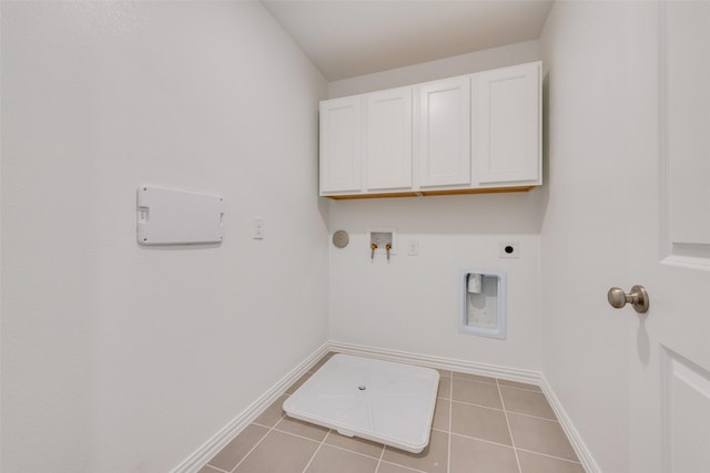 clothes washing area with tile patterned flooring, hookup for a washing machine, hookup for an electric dryer, baseboards, and cabinet space