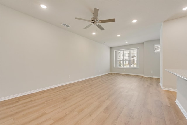 unfurnished room with light wood-type flooring, visible vents, and recessed lighting