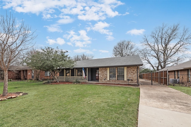 single story home featuring brick siding, fence, a porch, a front yard, and a gate