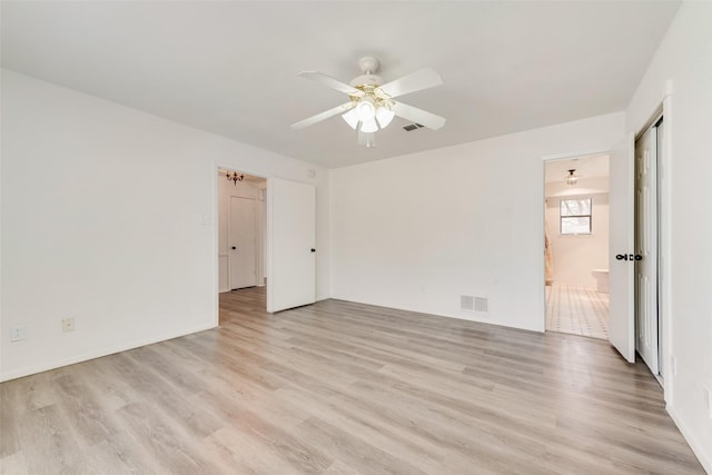 spare room with visible vents, ceiling fan, and light wood-style floors