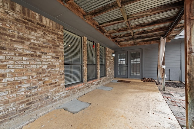 property entrance with brick siding and french doors