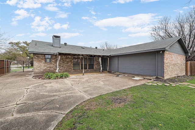 single story home featuring fence, driveway, an attached garage, a chimney, and brick siding