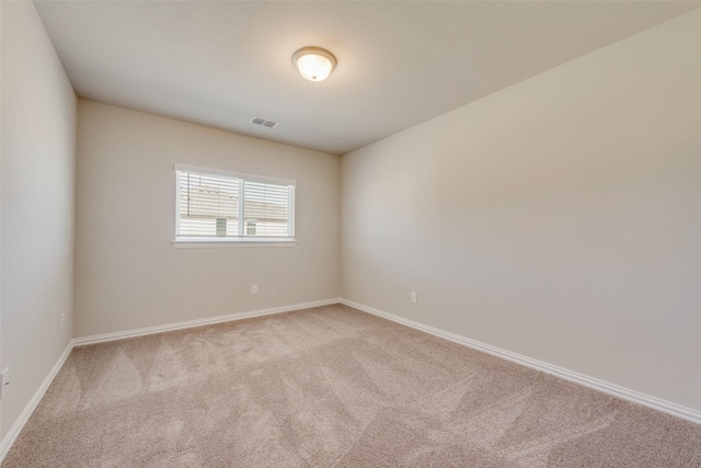 empty room with light carpet, baseboards, and visible vents