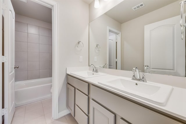 bathroom featuring double vanity, visible vents, a sink, and tile patterned floors