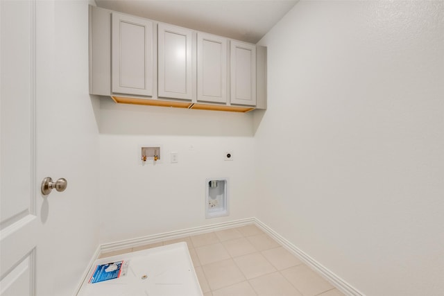 laundry room featuring light tile patterned flooring, washer hookup, baseboards, cabinet space, and electric dryer hookup