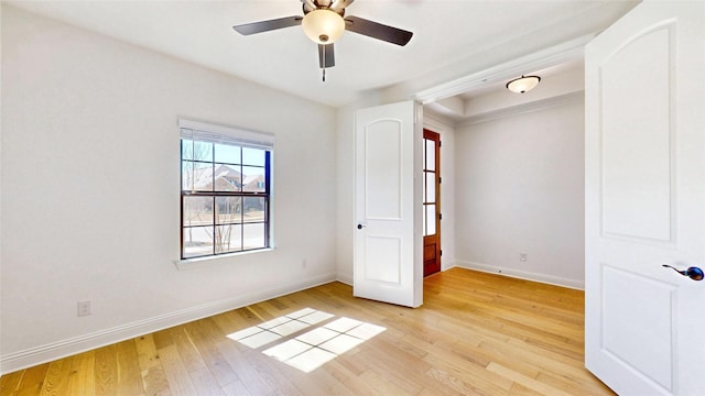 unfurnished bedroom with a ceiling fan, baseboards, and light wood finished floors