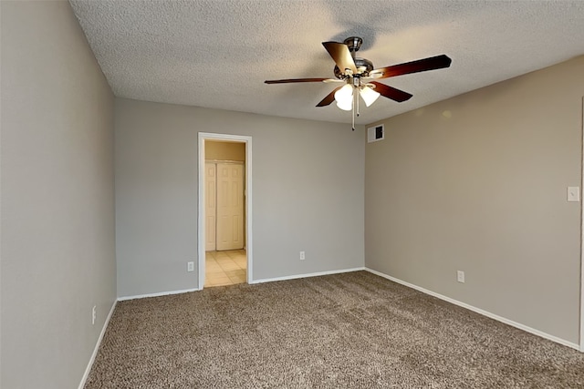 unfurnished room with light carpet, baseboards, visible vents, and a ceiling fan