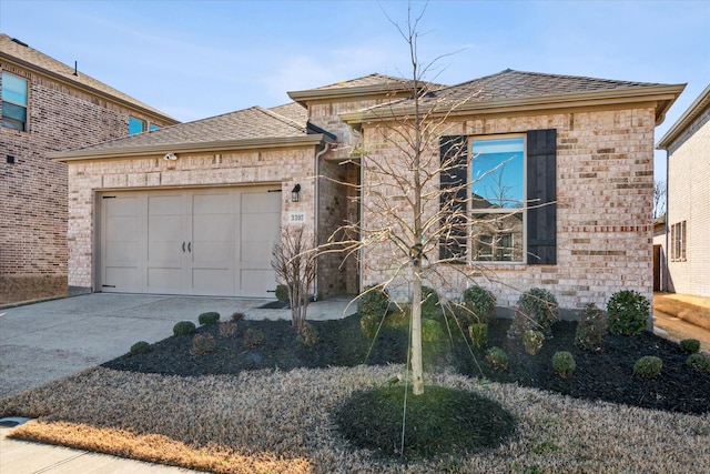 view of front of home featuring a garage, driveway, brick siding, and roof with shingles