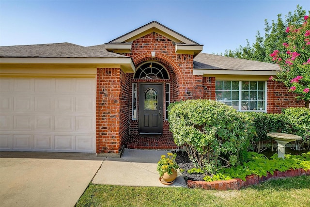 view of front of property featuring brick siding, roof with shingles, and an attached garage