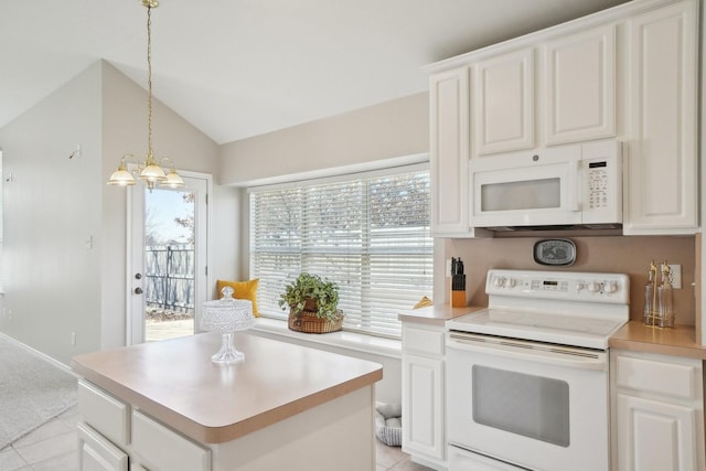 kitchen featuring lofted ceiling, white appliances, a kitchen island, white cabinets, and light countertops