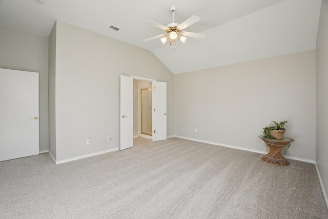 unfurnished bedroom featuring baseboards, visible vents, a ceiling fan, vaulted ceiling, and carpet floors