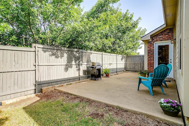 view of patio with a fenced backyard and area for grilling