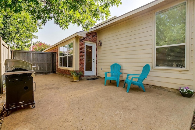 view of patio featuring fence and area for grilling