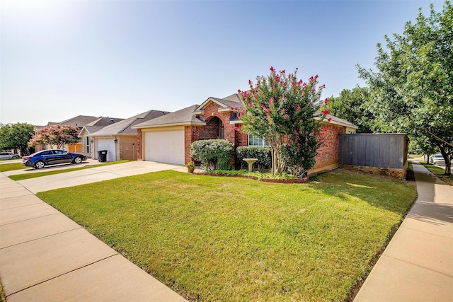 view of front of home with driveway, a garage, brick siding, fence, and a front yard