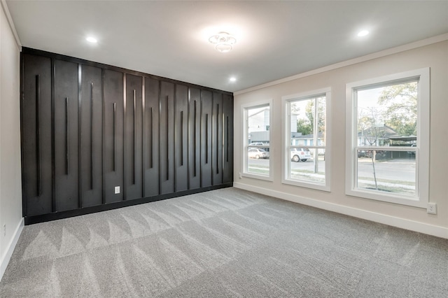 carpeted empty room featuring baseboards, ornamental molding, and recessed lighting